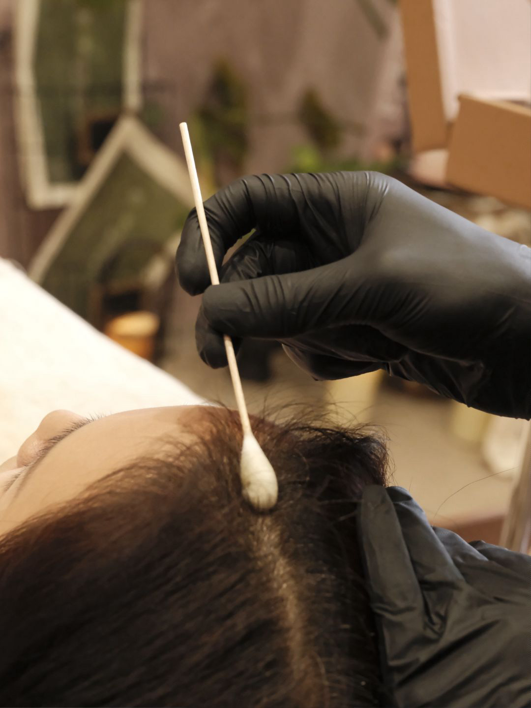 Close-up of scalp detox treatment using cotton swab for precise scalp care
